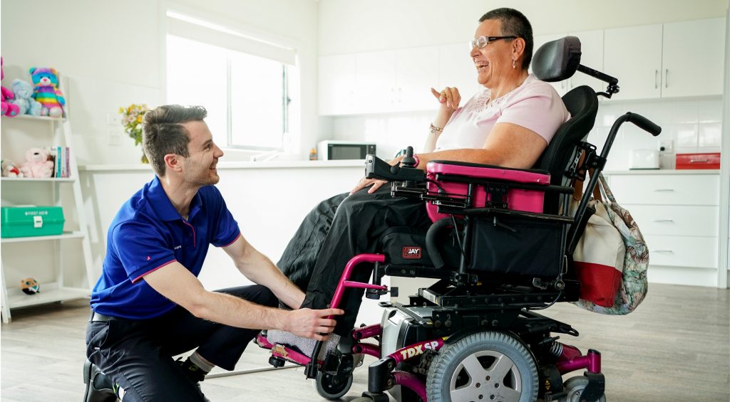 Therapist helps client in wheelchair