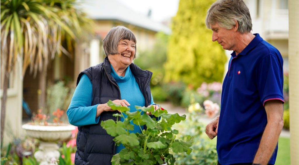 Two hendercare workers in the garden - click to watch the home care package video